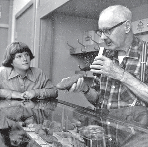 A girl and a man discussing fossils. 