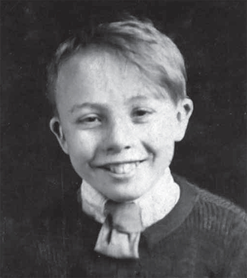 A boy , Roy Caley, smiling.