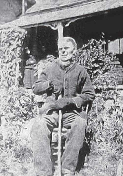 Stephen Catt sitting outside in front of a building.