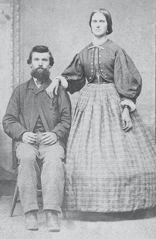 Joseph Clark sits beside his wife Hannah Linnell who is standing.