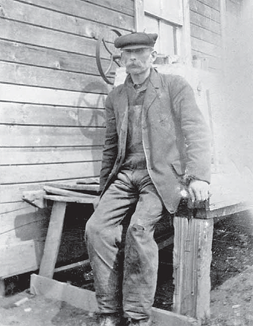 John Dolan sitting on a wood table.