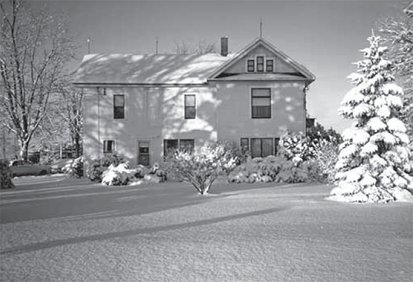 Ernest Faulds 2 storey home in the winter.