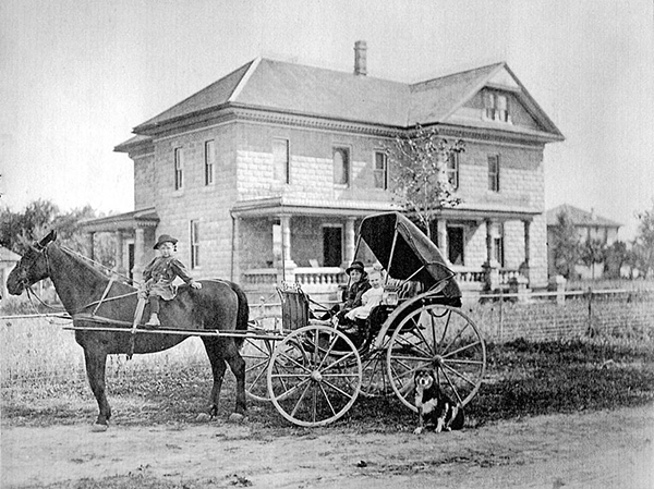 Kenzie children on a carriage and horse.