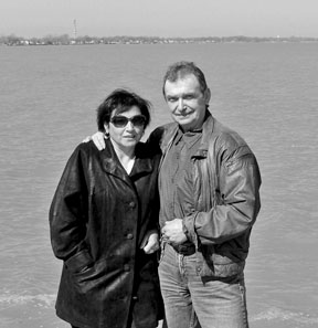Anna and Karel Kyncl stand in front of a body of water.