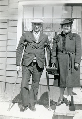 William on crutches standing beside Ida (Kilmer) Waun.