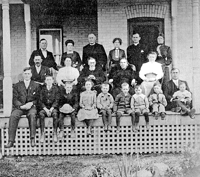 A large family, the Westgates, sitting on a porch.