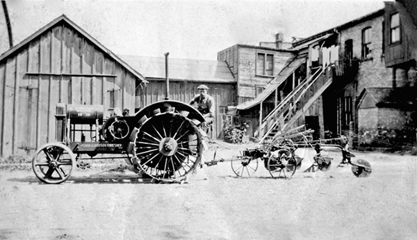 Richard Williams on a tractor pulling some equptment.