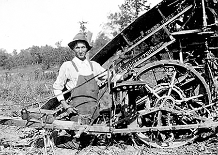 Man repairing a corn binder.