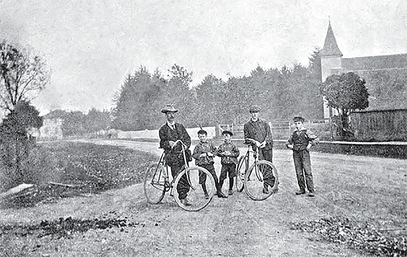 Two men with bikes and three children.