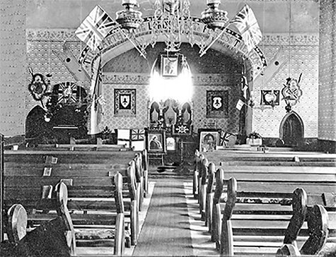 Inside original Anglican Church where there are many British flags.