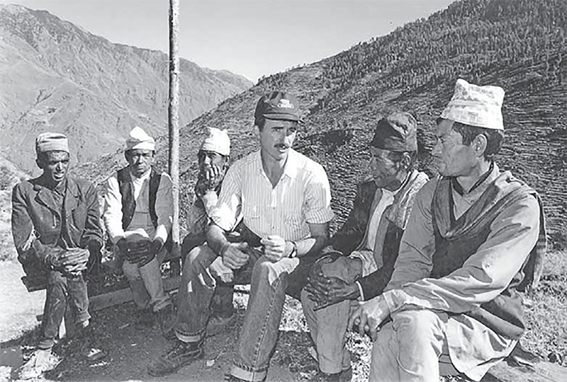 Norman Holbrook sitting with some locals in Nepal.