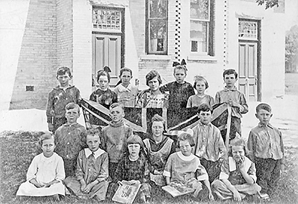 A group of school children in front of the school house,SS#11.