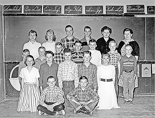 Students and teacher from SS#6 stand in front of a blackboard, 1959.