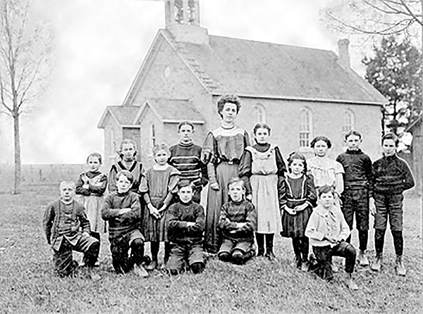 School house SS#5 with students and a teacher in front.