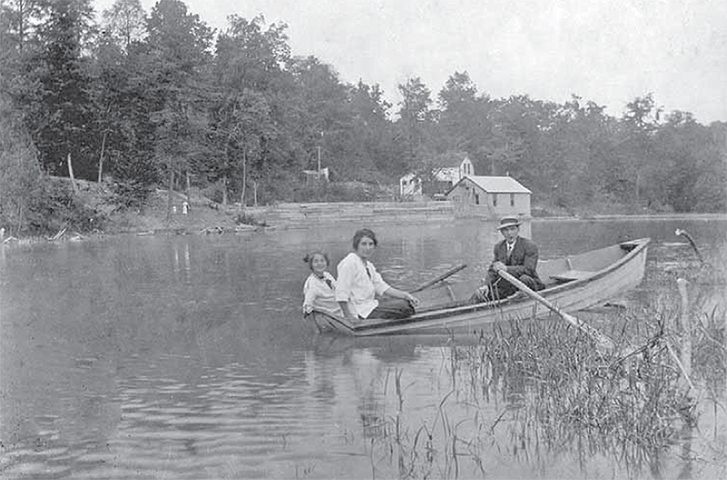 Two women and a man boating at Rock Glen Mill Pond.