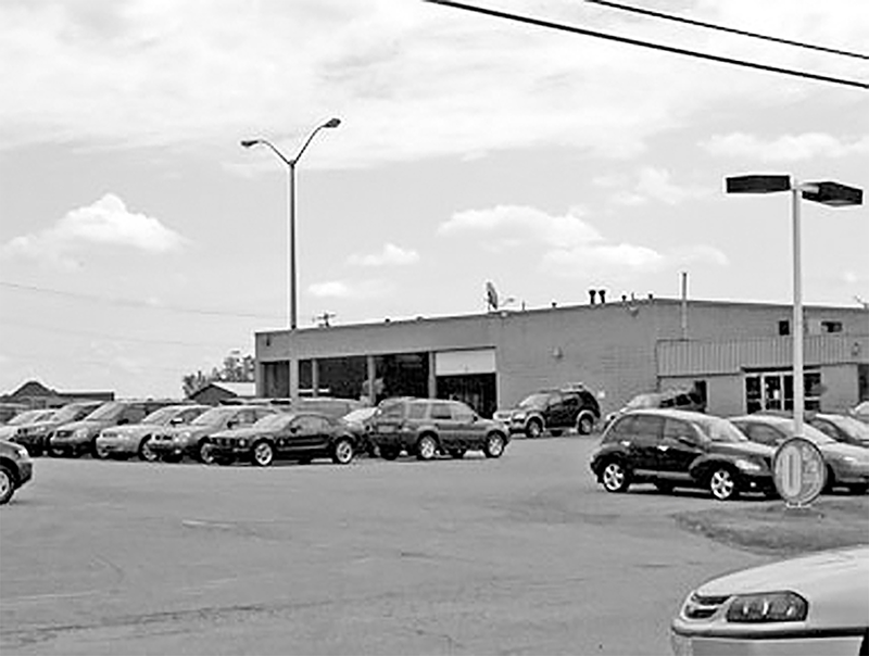 Bluewater Ford Garage with many cars for sale out front.