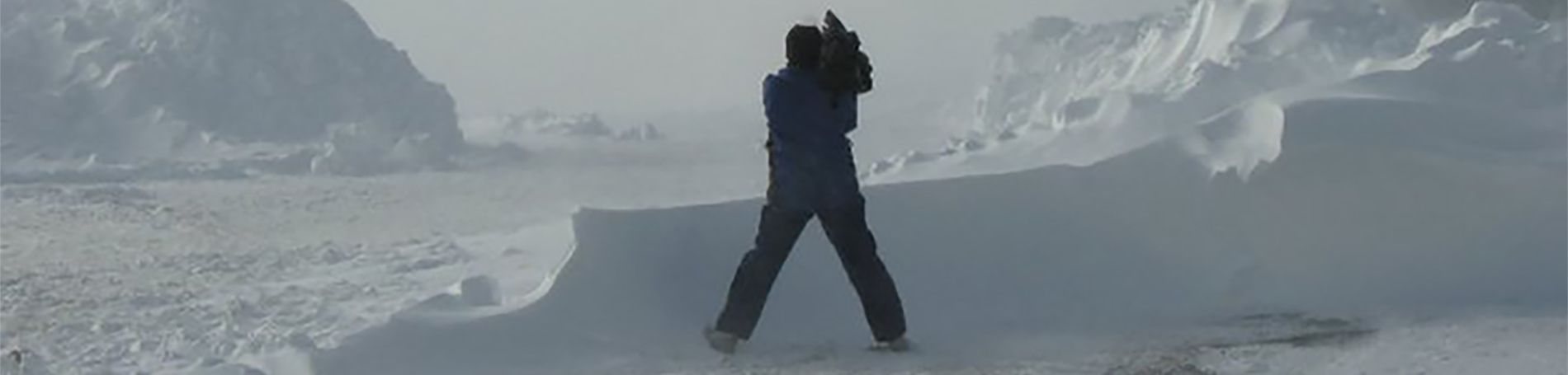 Photographer taking a photo in the snow. 