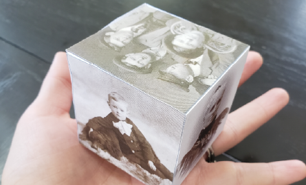 a hand holding a photo cube