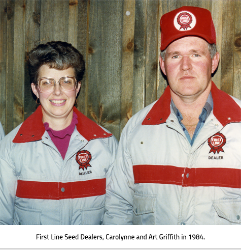 Carolynne and Art in first line seed dealer jackets. Image Caption: "First Line Seed Dealers, Carolynne and Art Griffith in 1984."