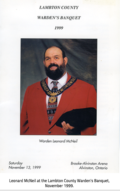 "Lambton County Warden's Banquet 1999" card. Text reads: "Warden Leonard McNeil" "Saturday November 13,1999 Brooke-Alvinston Arena Alvinston, Ontario". Image Caption: Leonard McNeil at the Lambton County Warden’s Banquet, November 1999. 