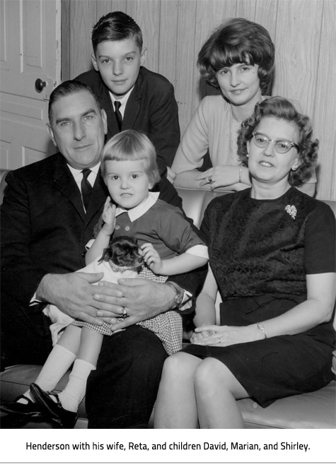 A black and white family photo of Henderson and his wife sitting with 2 children behind them and the youngest sitting on Henderson's lap. The family is dressed up. Image Caption: Henderson with his wife, Reta, and children David, Marian, and Shirley.
