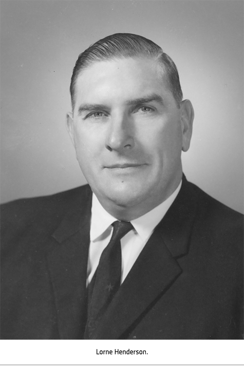 Man with combed back hair and wearing a black suit. Image Caption: Lorne Henderson