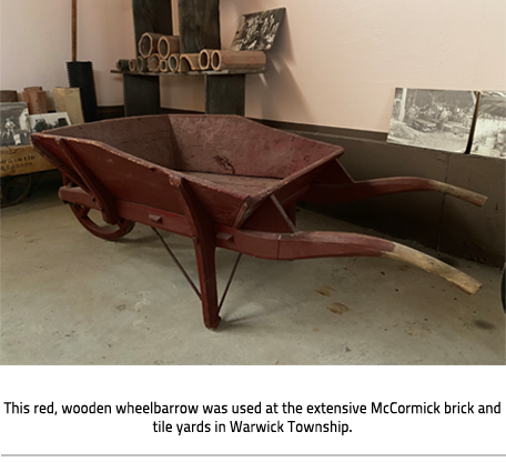 Image Caption: This red, wooden wheelbarrow was used at the extensive McCormick brick and tile yards in Warwick Township. 