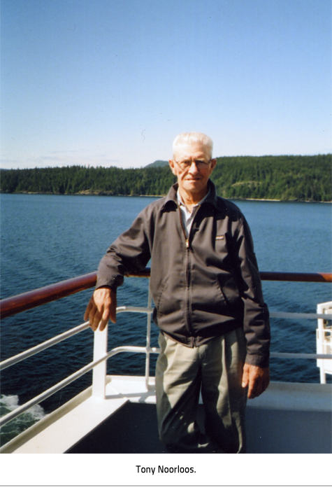 (Tony standing on a boat with his arm slung over the rail. A beautiful green treed coast is visible across the water.Image Caption: "Tony Noorloos"), link.