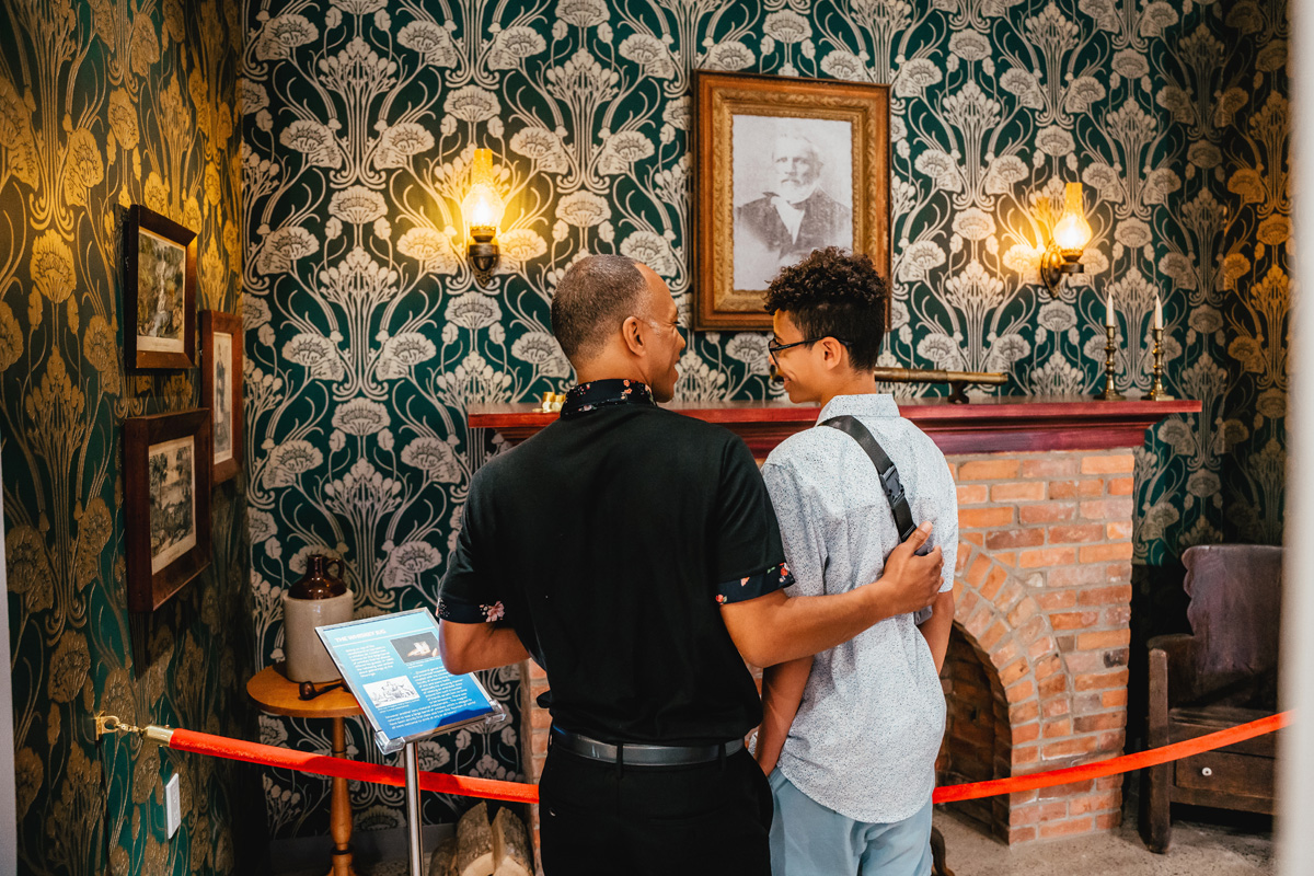 Father and son admire a fireplace in the Lambton Gallery at Lambton Heritage Museum