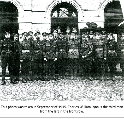 Photo of a group of men in uniform lined up in front of a building, link.