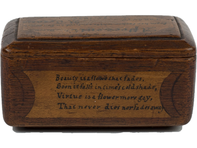 (Side View: Wooden box carved by prisoner. Poetic words are carved onto the side.), link.