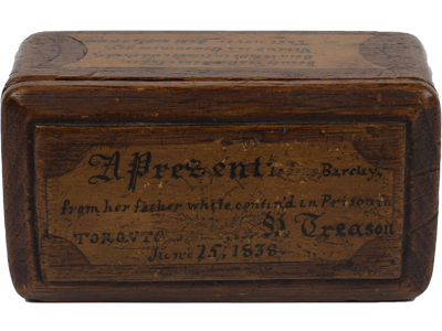 (Top View: Wooden box carved by prisoner. Poetic words are carved onto the top.), link.