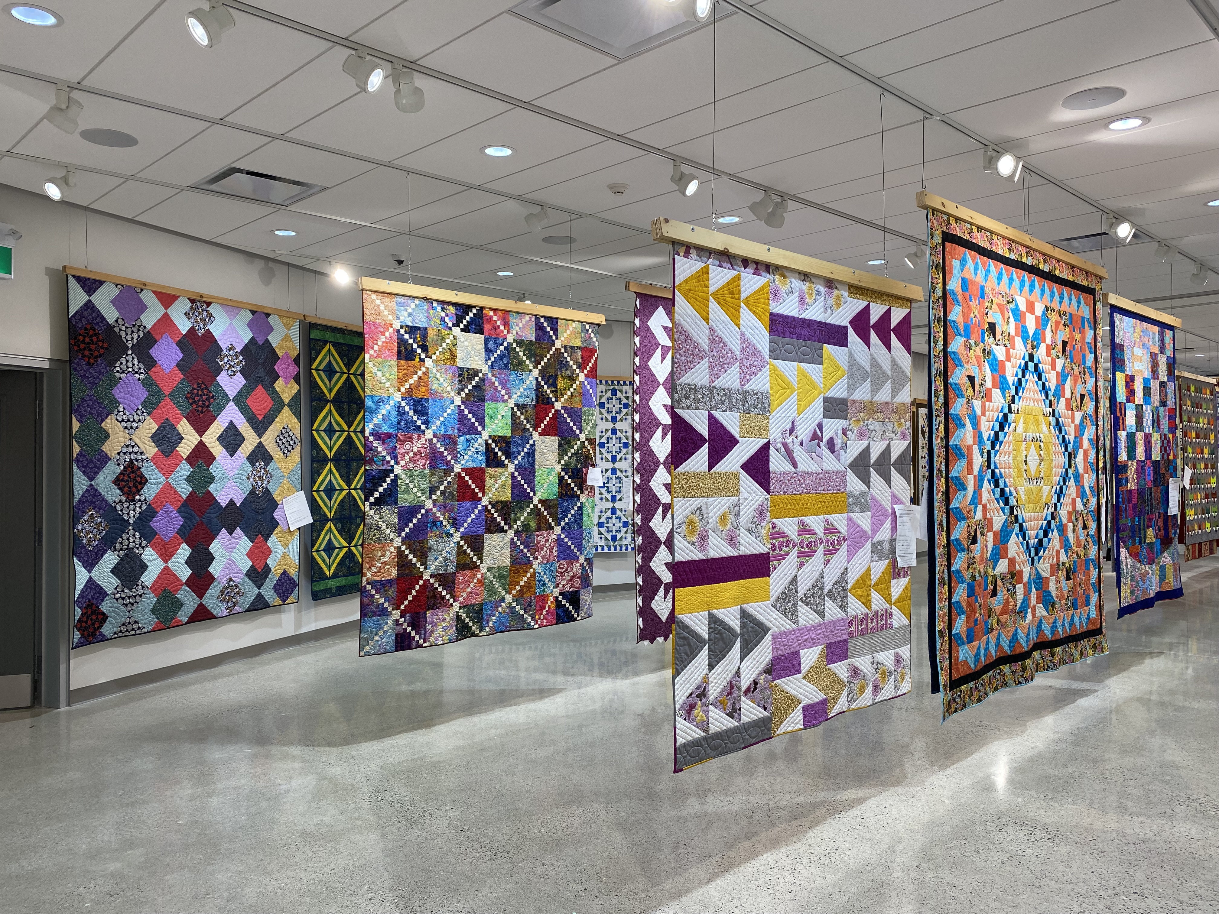 Colourful Quilts hanging on display
