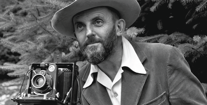Black and white image of man with old camera.