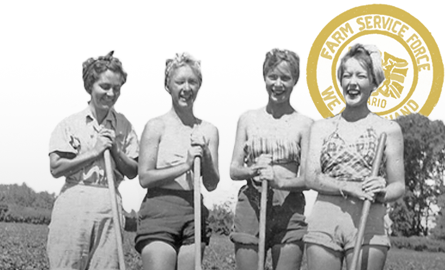 black and white photo of four women from the 1940s in a field.