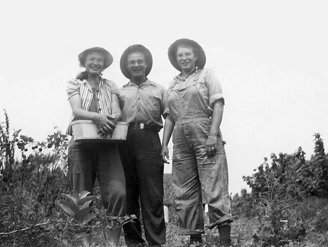Ursula Rosser stands in a field with Lorne and his sister Ruth Teeple.