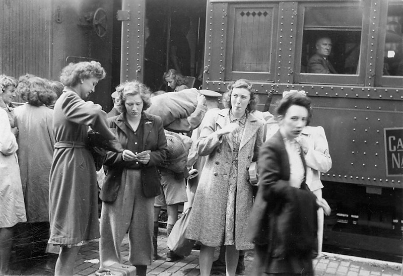 Girls disembarking a train.