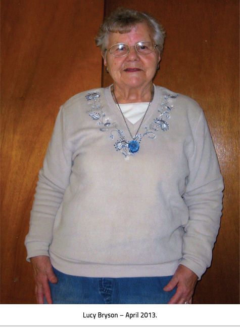 (Older woman in a sweater, jeans and wearing a blue pendant necklace. Image Caption: "Lucy Bryson-April 2013"), link.