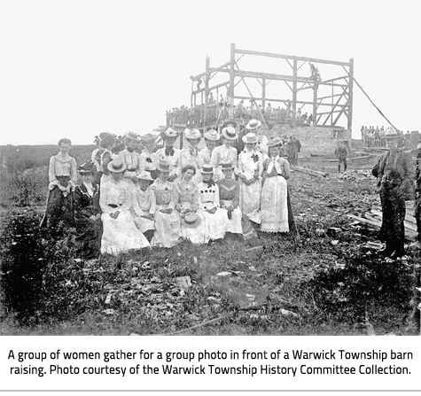 (Image Caption: "A group of women gather for a group photo in front of a Warwick Township barn raising. Photo courtesy of the Warwick Township History Committee Collection."), link.