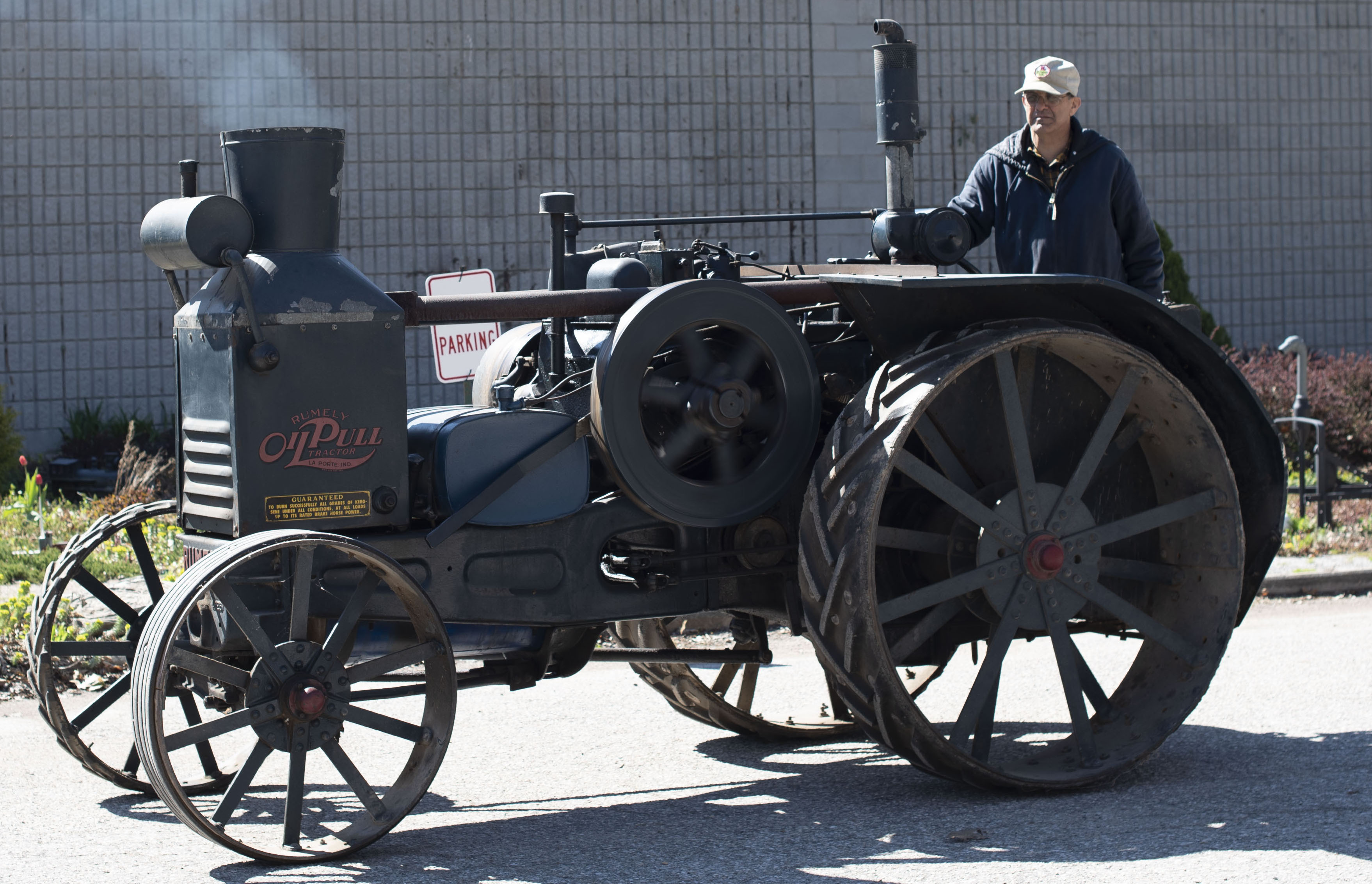 Lambton Heritage Museum staff member Jeremy Robson driving the historic Rumely tractor