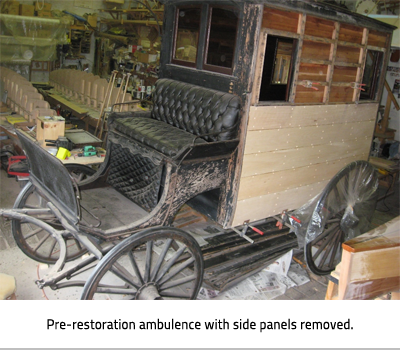 (Old horse and buggy with caption: "Pre-restoration ambulance with side panels removed."), link.