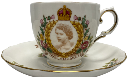 Glass teacup and saucer with Queen Elizabeth's portrait on it.