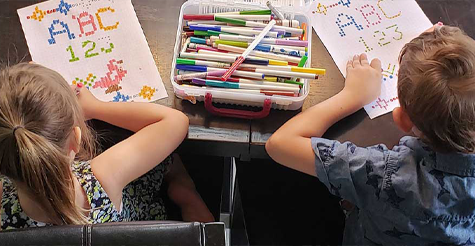 Two children working on a craft.