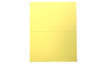 A yellow piece of paper cut in half.
