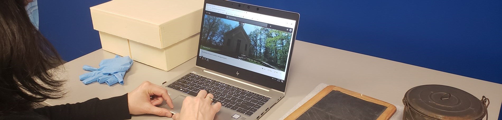 Person sitting at desk with laptop.