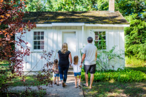 Family admiring the exterior of the Tudhop Home.