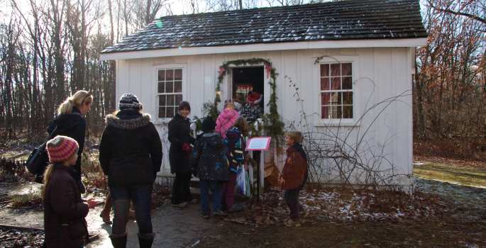 Children walking into white building.