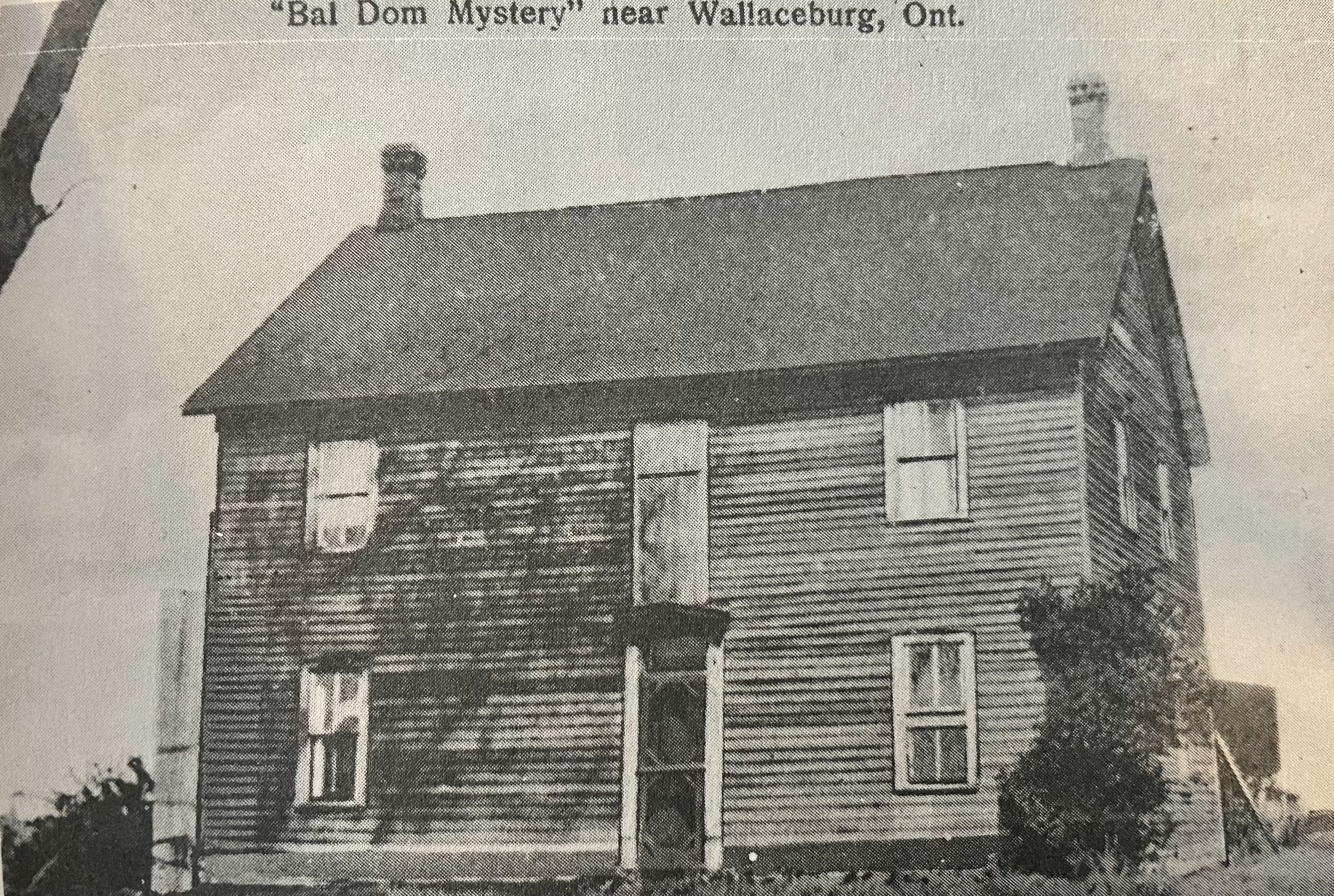 Black and white image of a house with text,