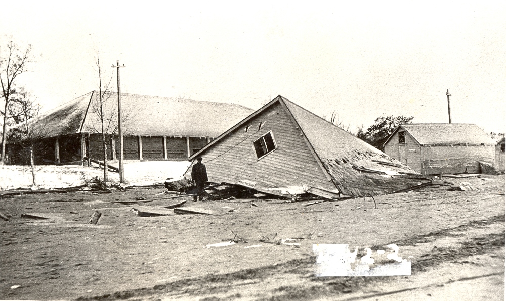 Black and white image of a building fallen down.