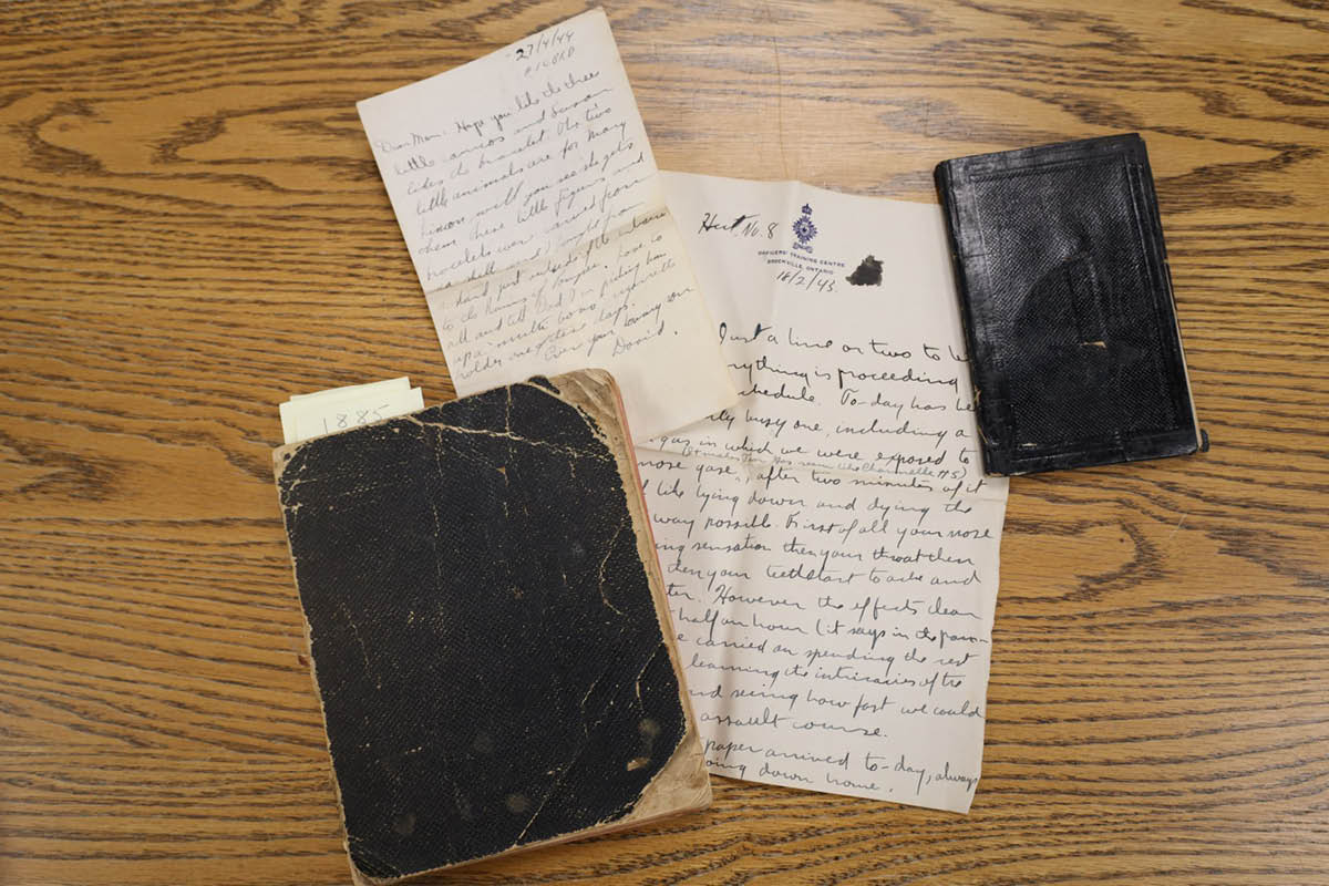Diaries and letters from Lambton County Archives' collection rest on a wooden desk surface.